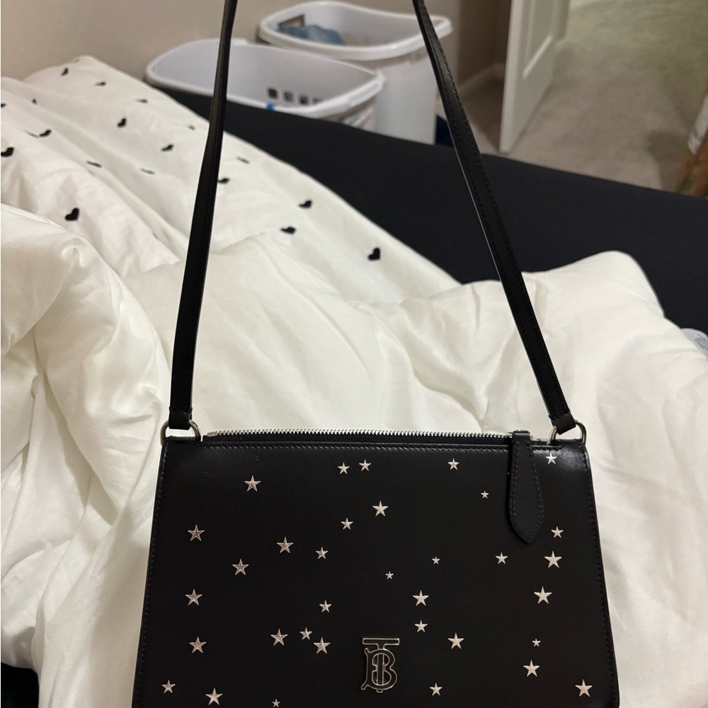 The Burberry TB Monogram Leather Star Print Pouch Purse (black w/ silver stars)